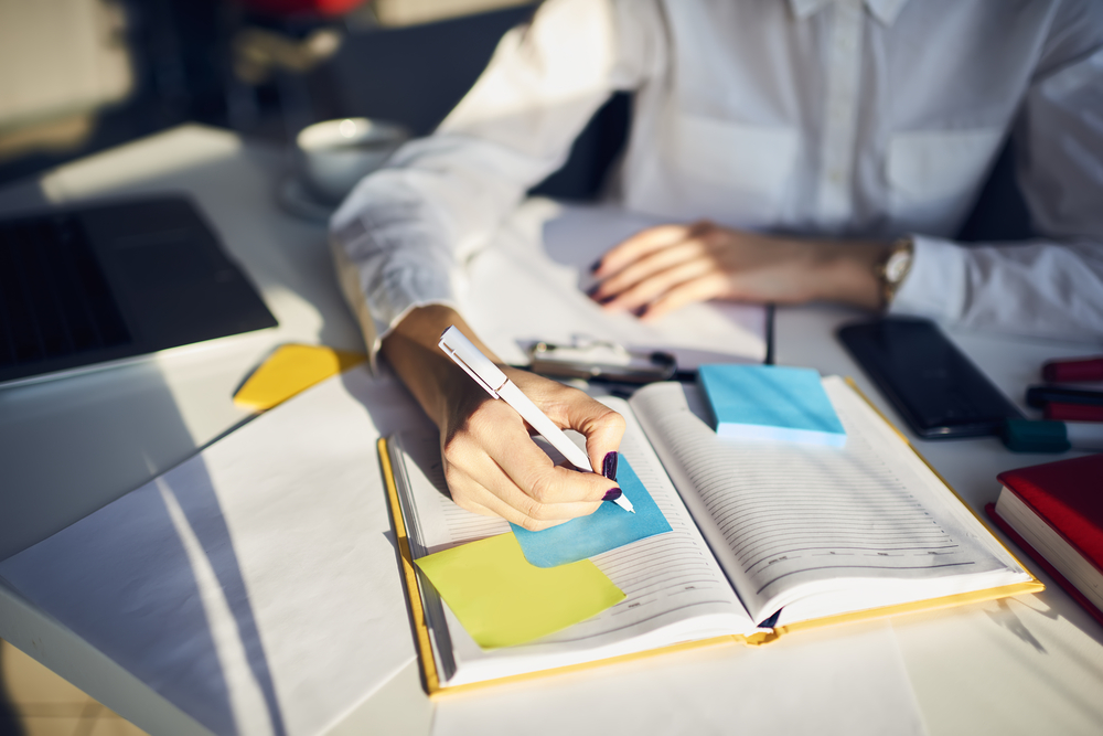 A caregiver working on a list of to-dos and a calendar