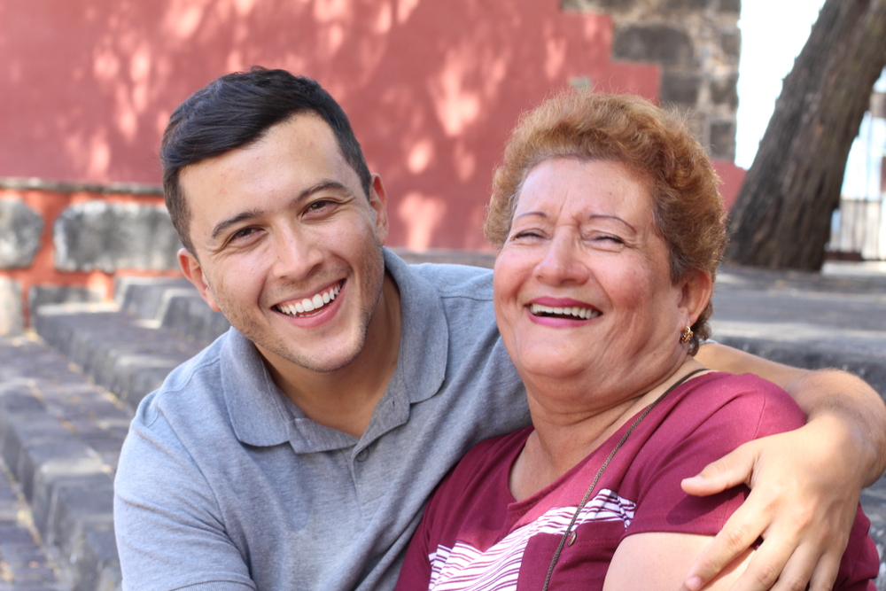 A laughing young man and his Hispanic mother