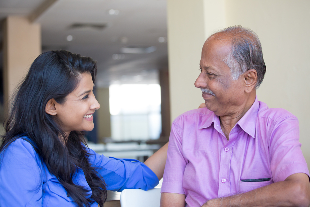 A young woman with her aging Indian father or grandfather