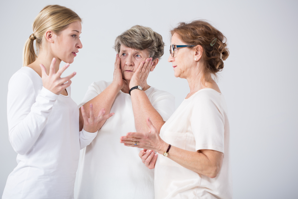 A group of three woman fighting in a white room