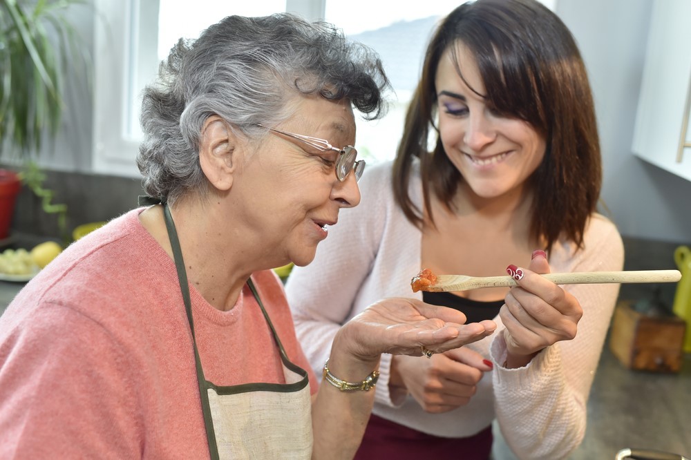 A carer cooking with a senior