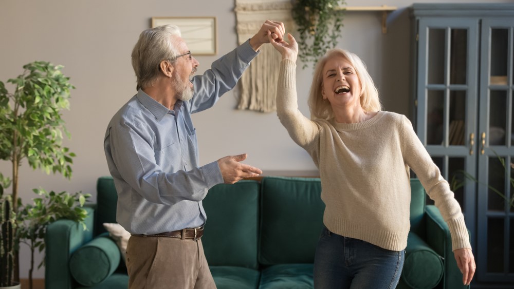 Two seniors laughing and dancing