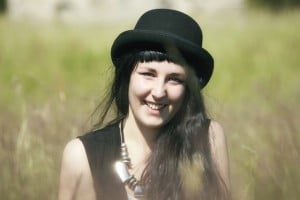 Young woman in a hat in a field