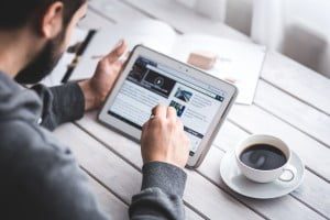 Man looking at news on a tablet