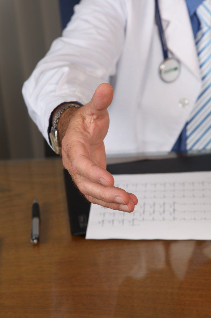 Doctor reaching out to shake hands