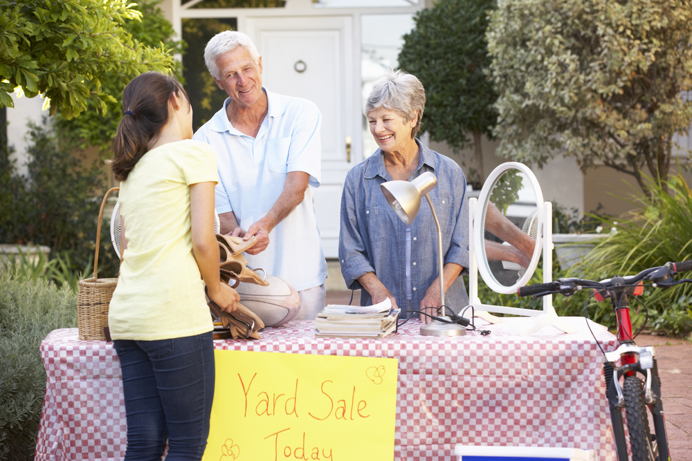 A senior couple selling items in their yard