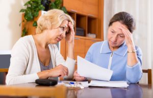 Two people looking at paperwork, highlighting the topic of advance planning