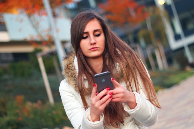 Upset woman texting