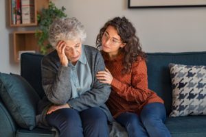 A granddaughter or daughter caring for a stubborn aging parent