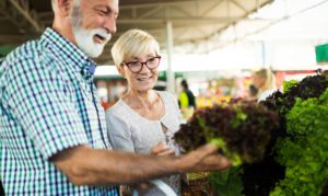 An elderly couple shopping for groceries, while trying to avoid grocery shopping mistakes