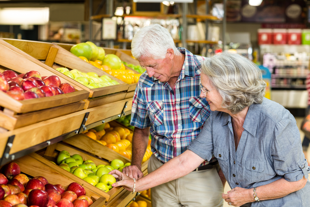 Two seniors shopping for groceries