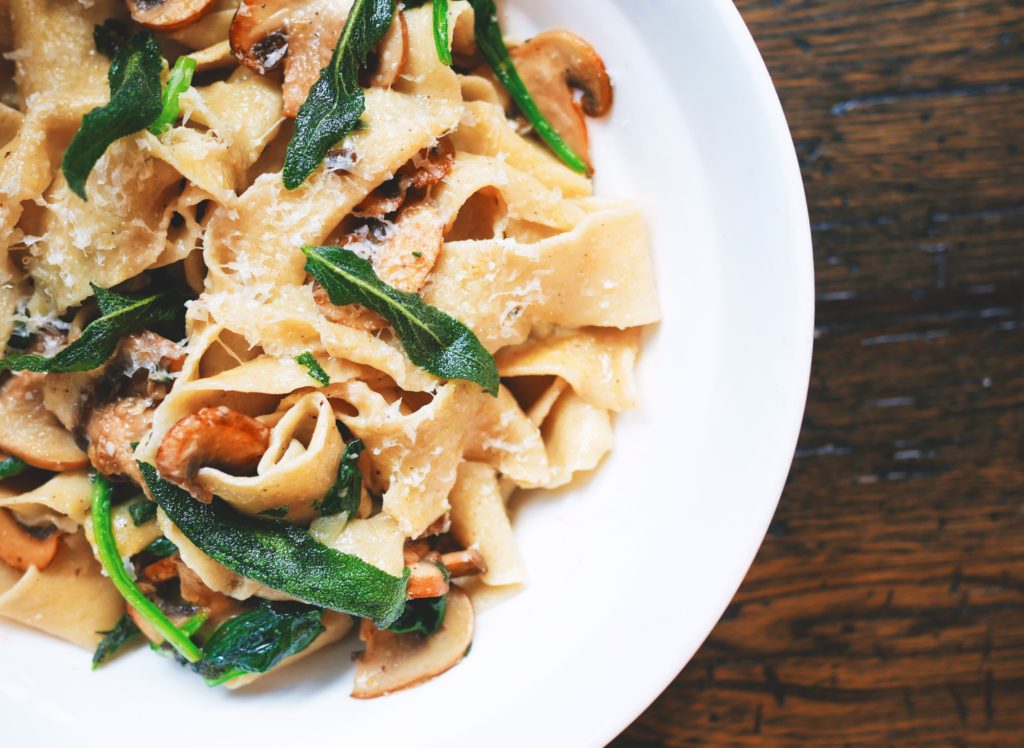 A fresh pasta meal on a white plate