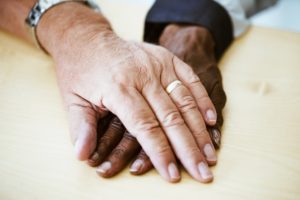 An older couple holding hands