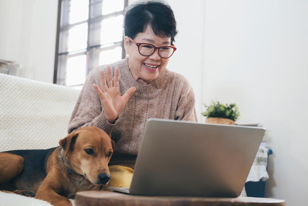 A senior woman using a laptop, engaging with one of the best social apps for seniors