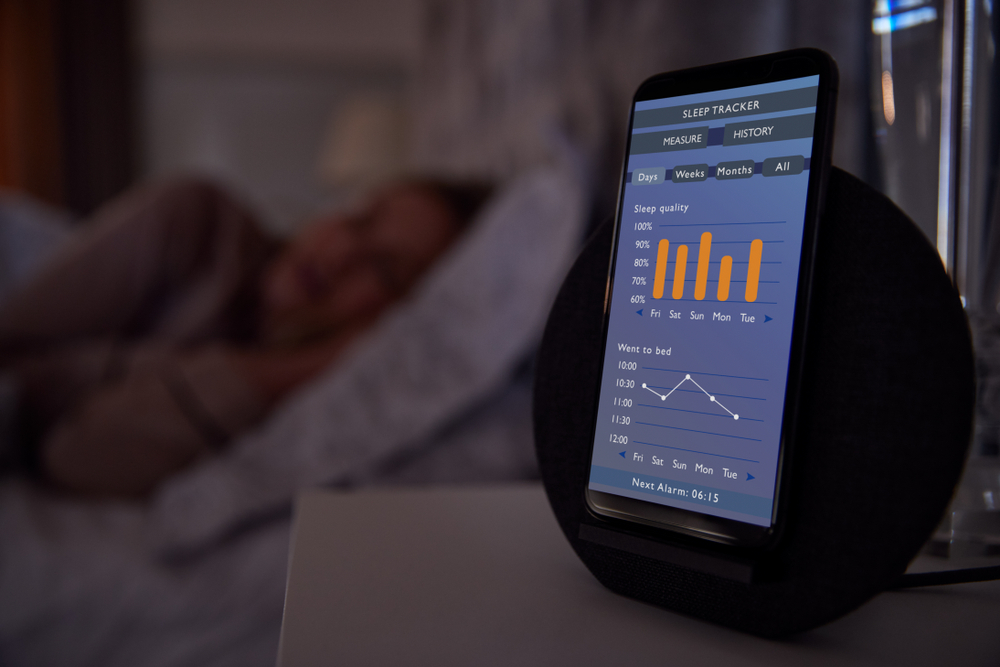 A sleep tracker app running on a cellphone on a table