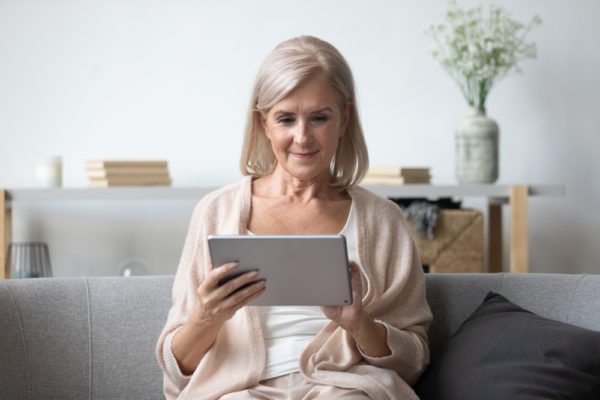 A senior woman looking at her tablet, highlighting the idea of memory game apps for seniors