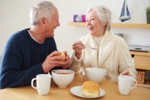 A senior couple in the kitchen enjoying a bowl of soup, focusing on the idea of nutritious soups for elderly