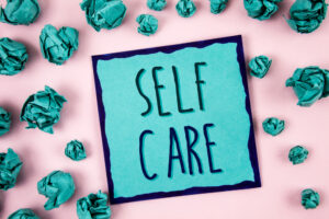 A teal piece of paper showing the idea of self care