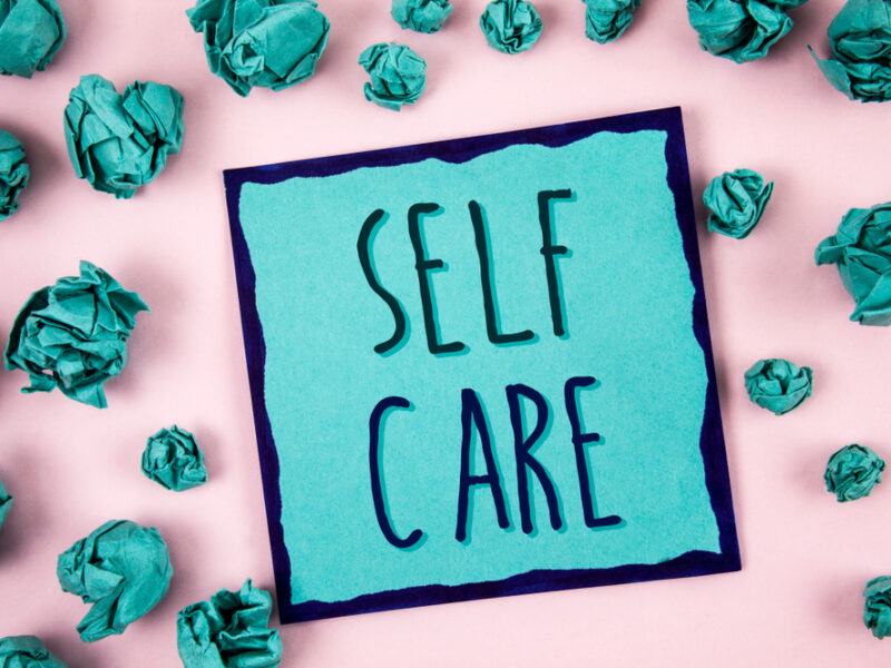 A teal piece of paper showing the idea of self care