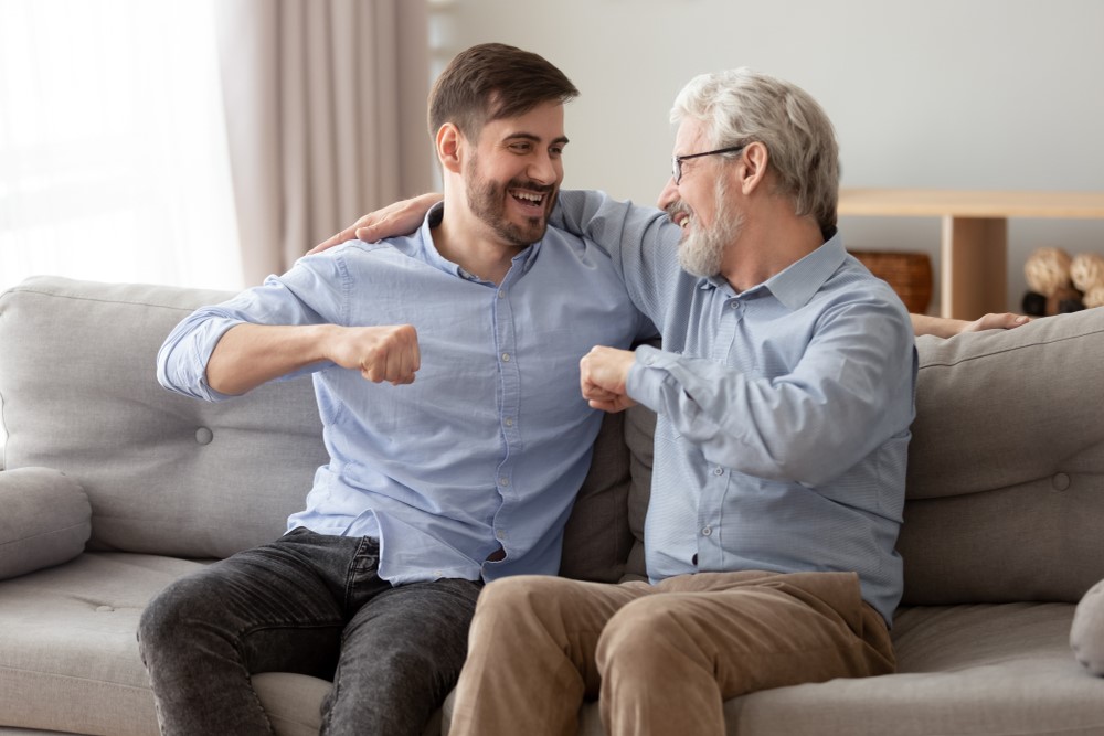 A happy senior man and his son