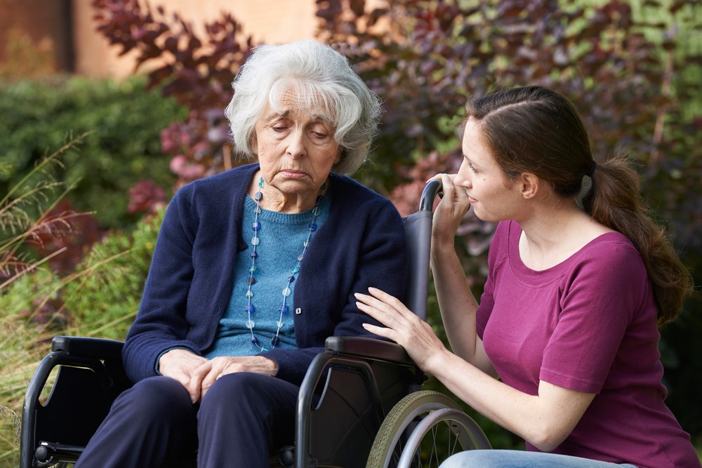 A younger woman comforting an older one