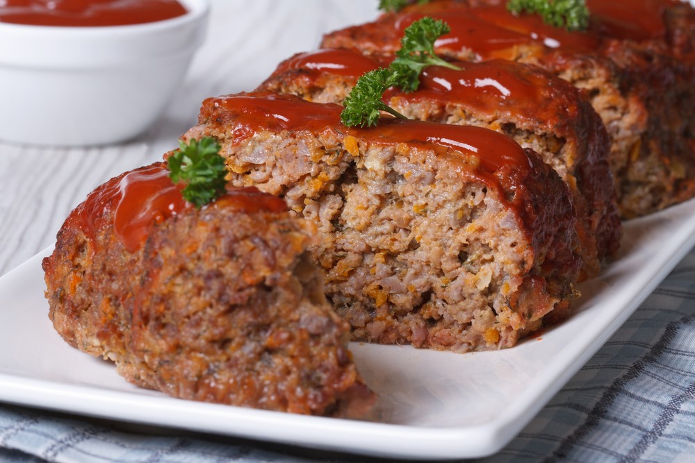 A meatloaf with tomato sauce on the top