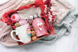 A pink subscription box for seniors, with a cup and bath products