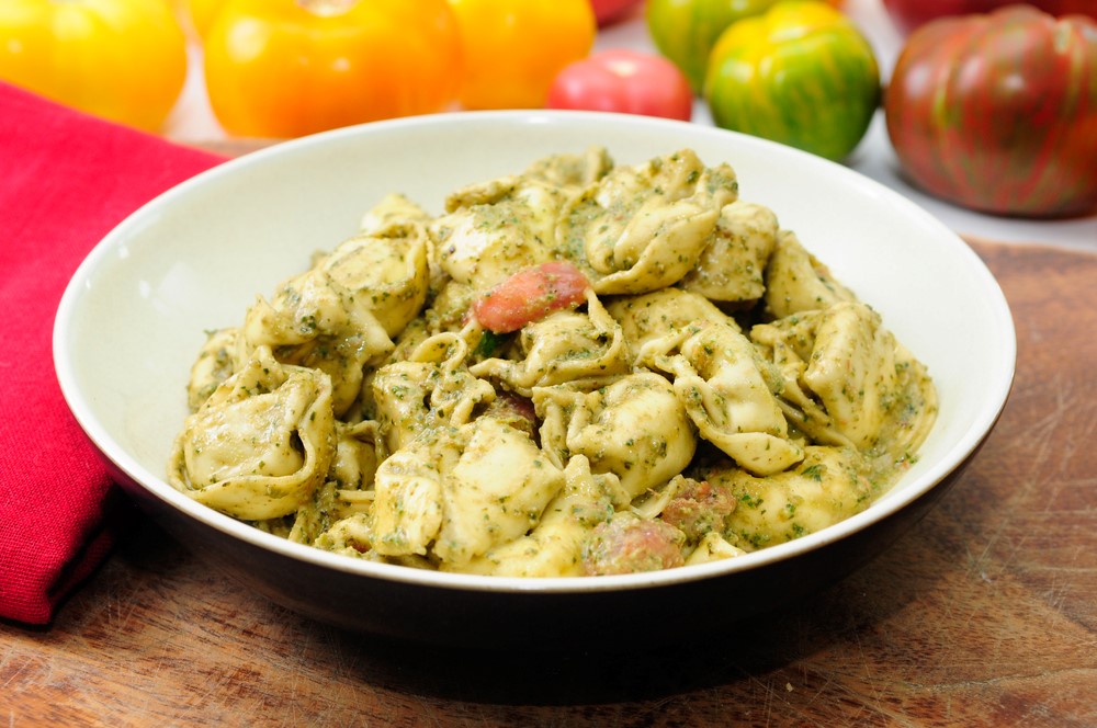 A white bowl with pesto tortellini bake