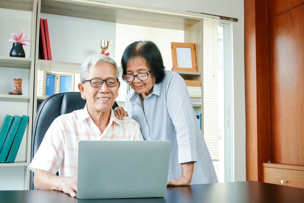 A Chinese American couple looking at Social Security information