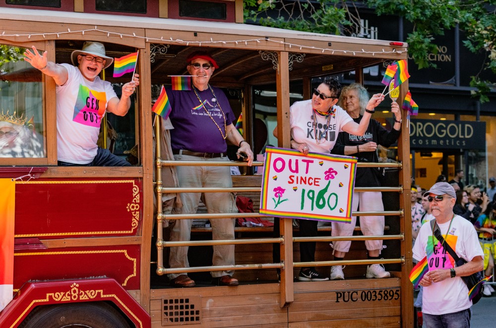 vA float at a Pride parade with seniors who have been out since 1960