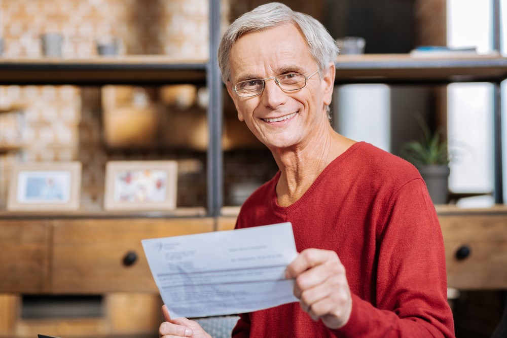 A pensioner looking at Social Security paperwork