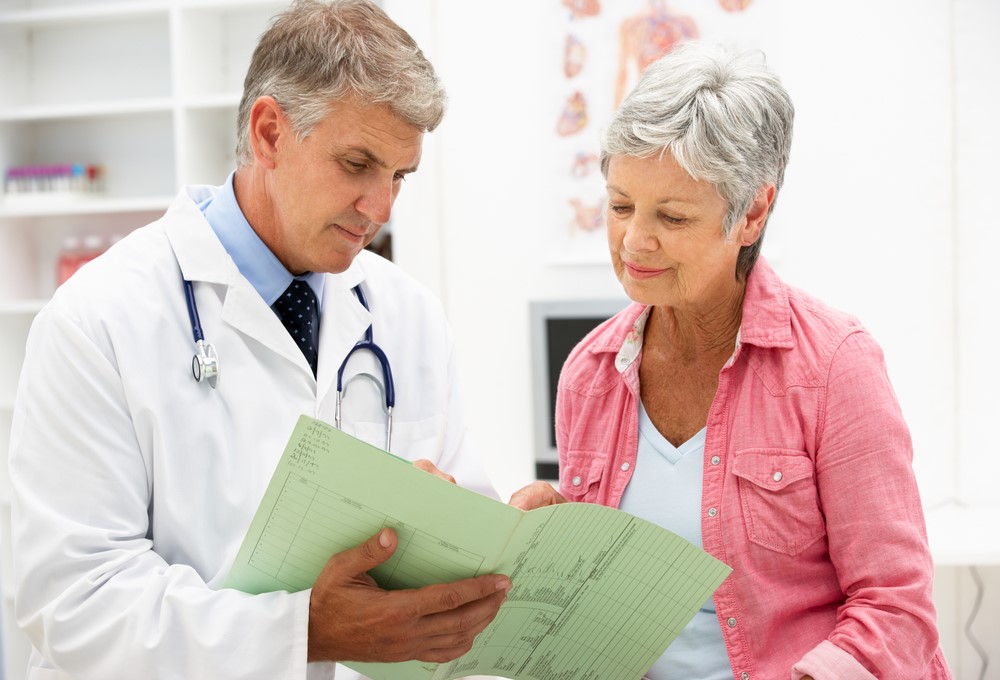 A senior woman talking to her doctor about health information that she may hide from her family