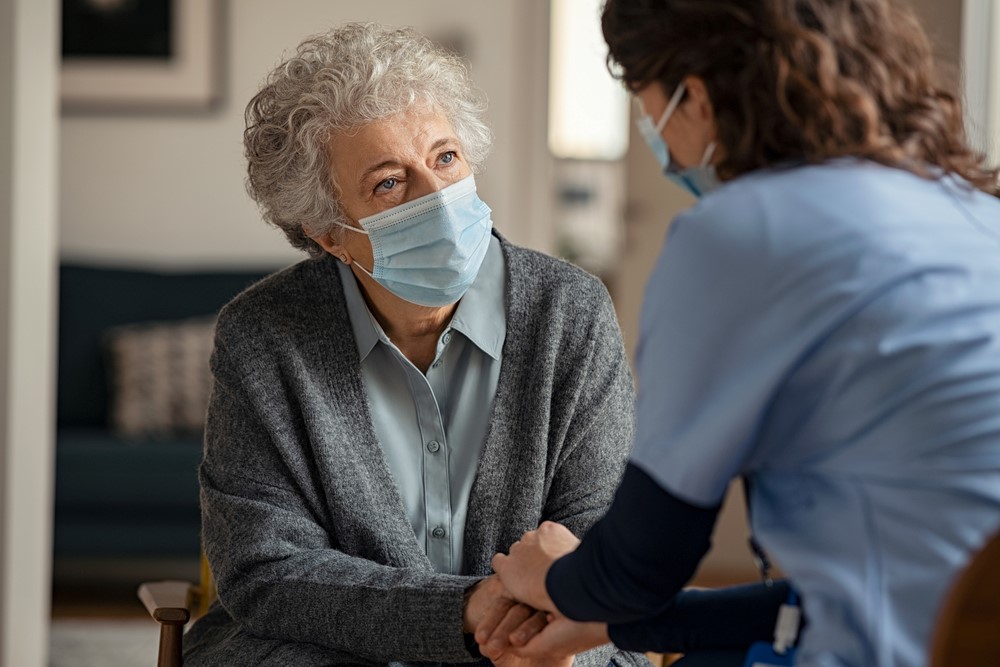 An elderly mother talking to her daughter or a nurse, talking about how the senior has been hiding health information