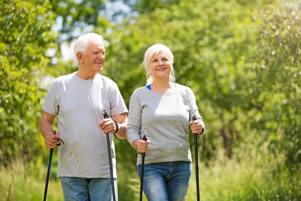 Two seniors using urban poling