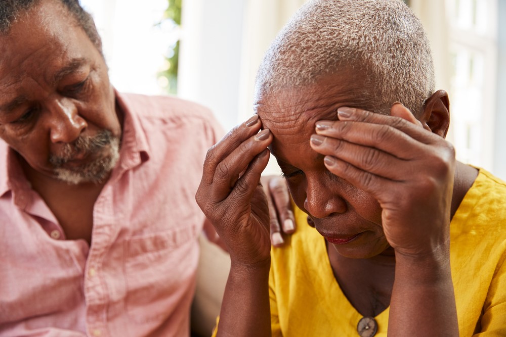 A senior man comforting a woman with depression