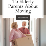 Two seniors moving into a new house, holding a large box