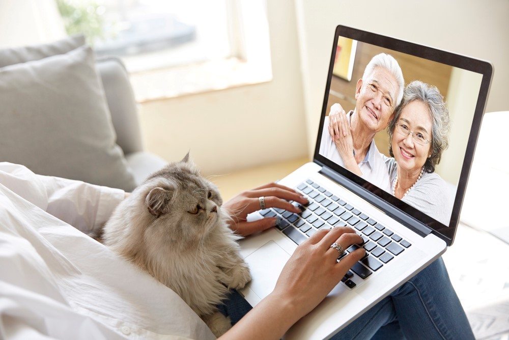 A Korean daughter talking to her aging parents via a laptop