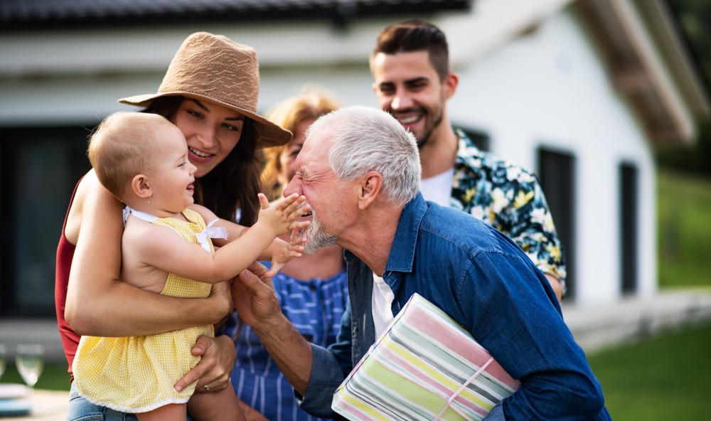 A grandfather playing with his granddaughter