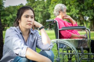 An upset daughter and her mother who is in a wheelchair, looking at whether it's possible to refuse care for elderly parents