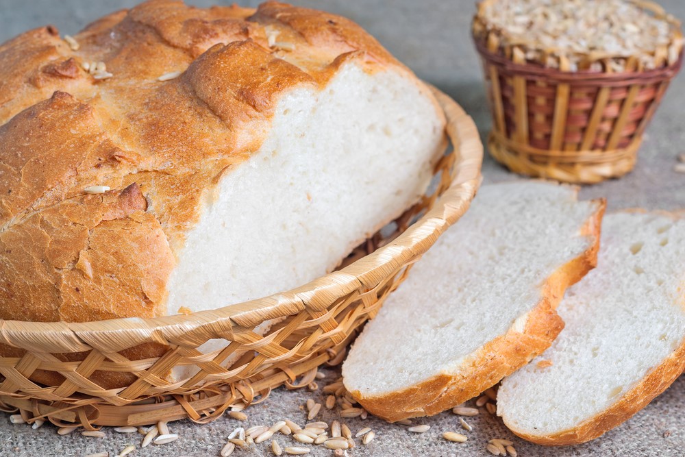 A loaf of white bread and some slices, showing how some food causes inflammation