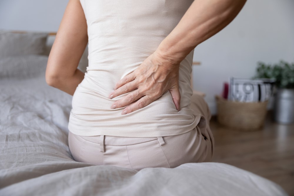 A senior woman with back pain