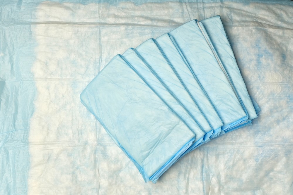 A senior woman holding an incontinence pad