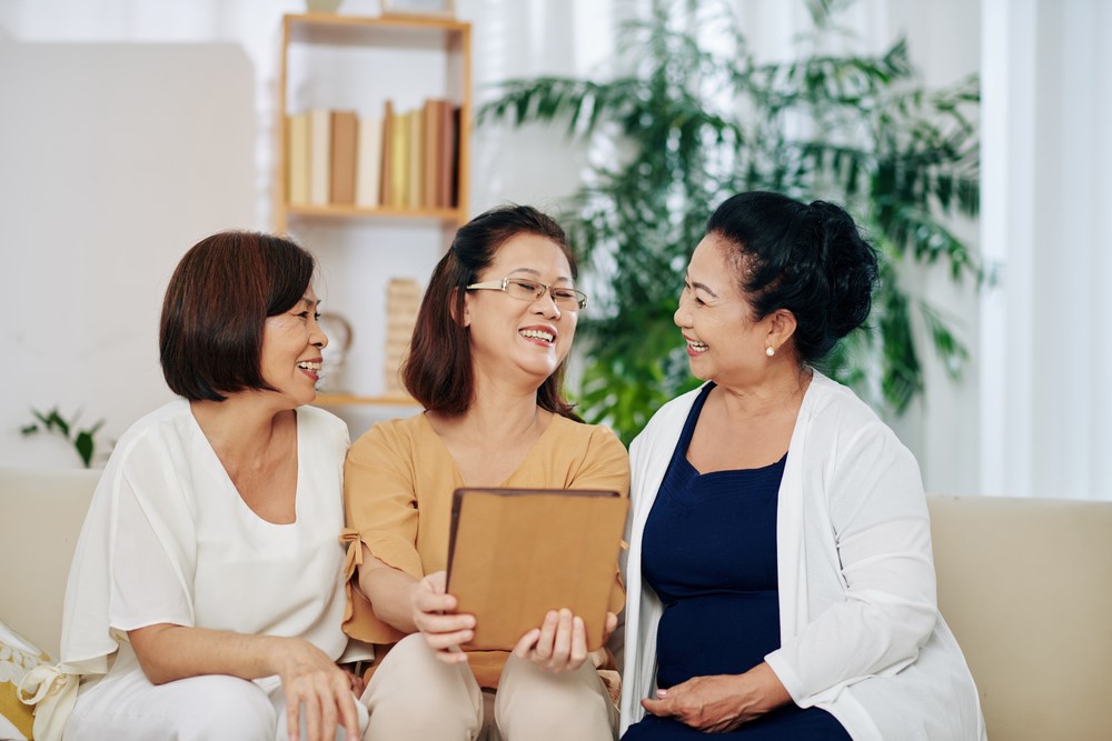 A Vietnamese family looking at a picture, showing the idea of Vietnamese caregiving