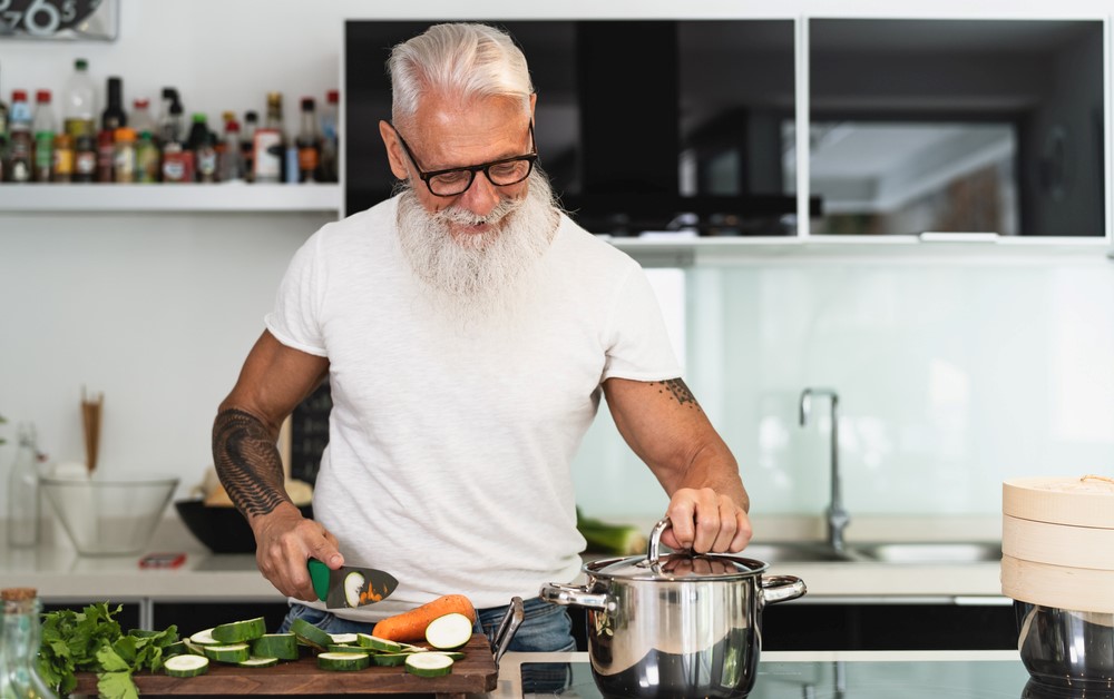 A hip older man cooking