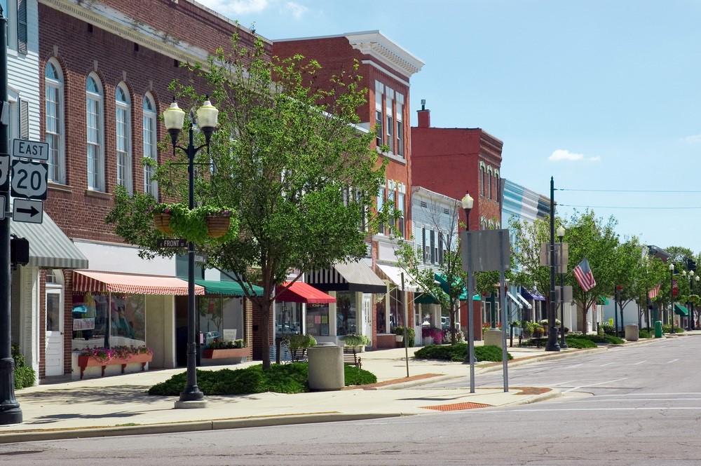 A midwest street in the United States, showing American flags, highlighting the idea of a U.S. retirement visa