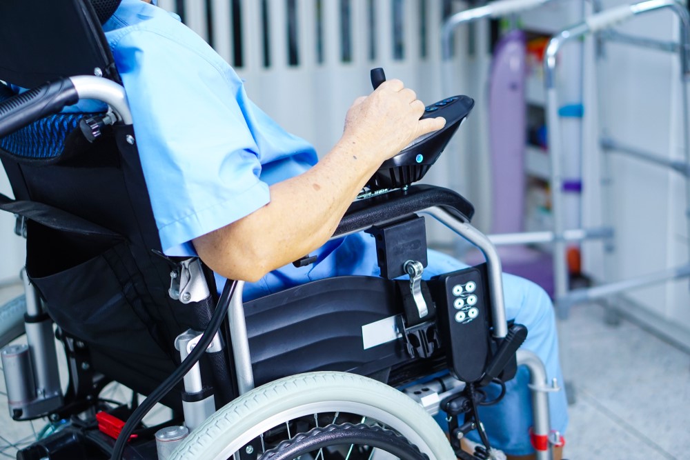 A senior sitting in an electric wheelchair