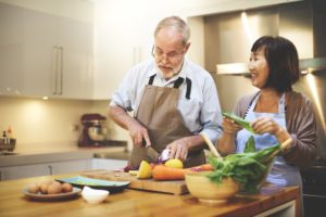 Two seniors cooking in a kitchen, highlighting why nutrition is important for the elderly