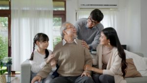 A multigenerational family where the senior has just moved in, highlighting the idea of whether a senior should live with his adult children