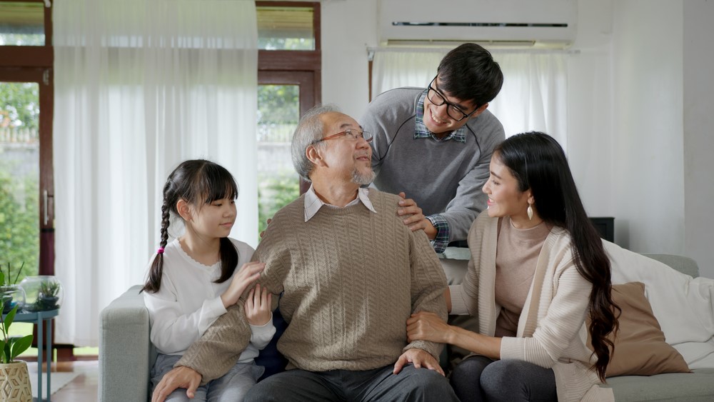 A multigenerational family where the senior has just moved in, highlighting the idea of aging in a multigenerational home.