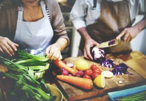 A senior couple preparing vegetarian food, as an example of vegetarian meals for seniors